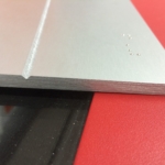 solid aluminum with a V grove cut in the sign with stainless Steel Grade 2 Braille