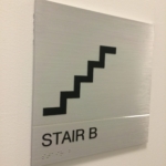 solid aluminum with a V grove cut in the sign with stainless Steel Grade 2 Braille