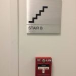 solid aluminum with a V grove cut in the sign with stainless Steel Grade 2 Braille