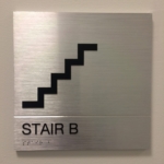 solid aluminum with a V grove cut in the sign with stainless Steel Grade 2 Braille